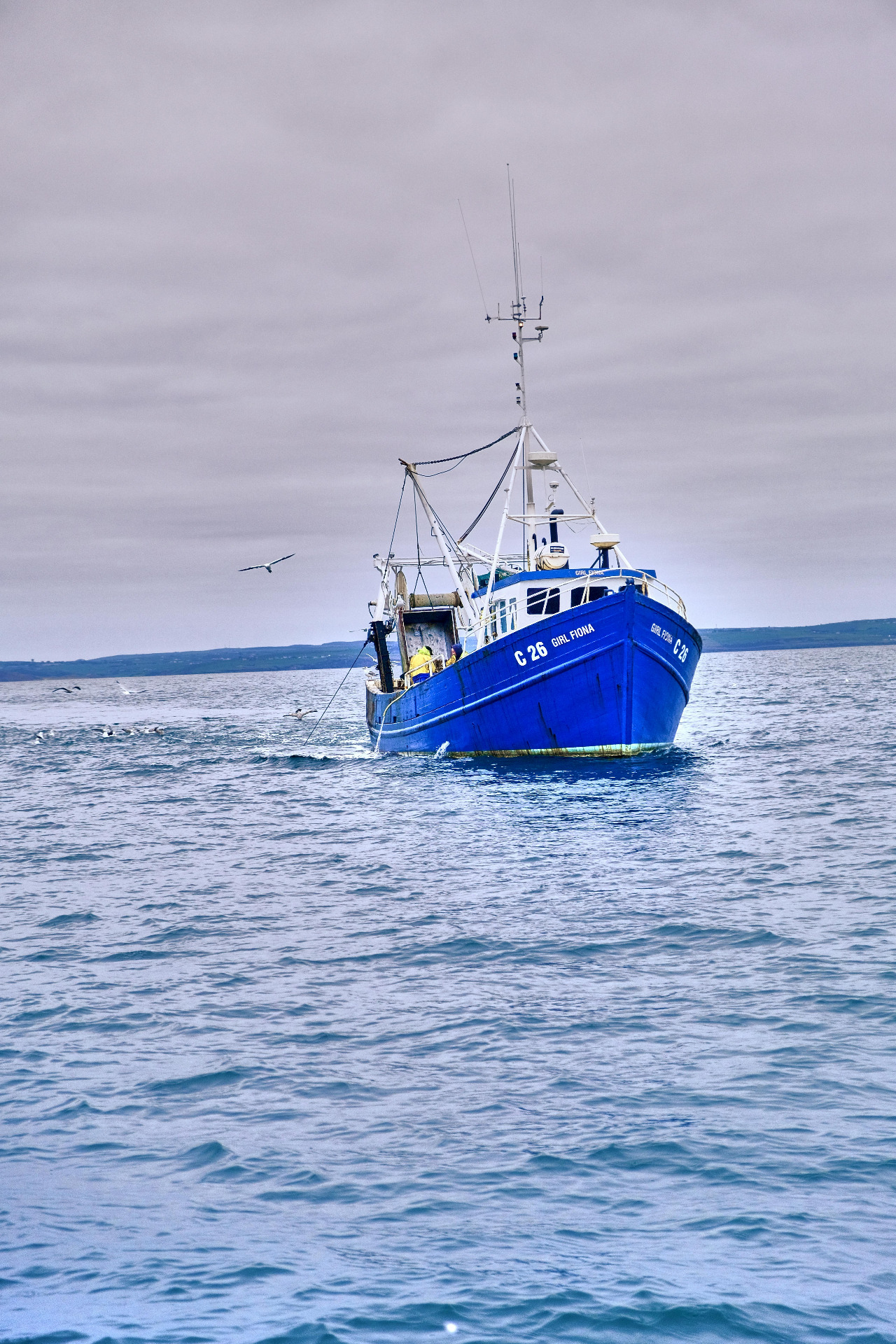 Irish fishing boat at Courtmacsherry, Co. Cork. Photo by Vijay Aditya M: https://www.pexels.com/photo/a-blue-fishing-boat-sailing-on-the-sea-10963950/